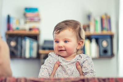 Happy baby toddler at home smiling in living room