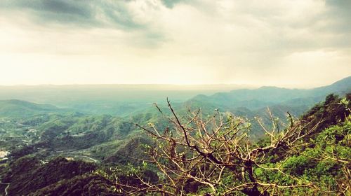 Scenic view of mountains against cloudy sky
