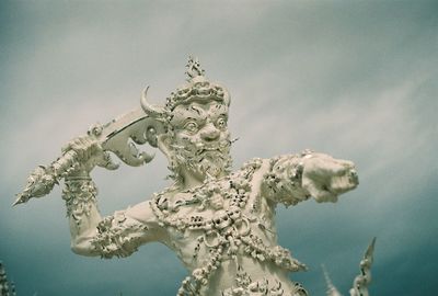 Low angle view of statue against sky