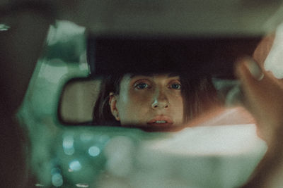 Portrait of man seen through car windshield