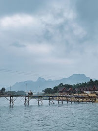 Bridge over bay against sky