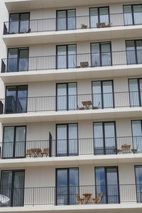 Low angle view of white building with balconies in city