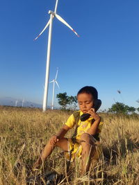 Boy on field against sky