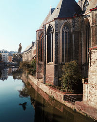 Reflection of building and trees on river