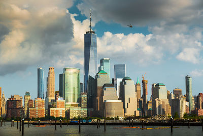 Modern buildings in city against cloudy sky