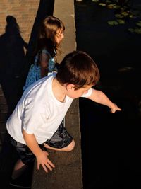 High angle view of mother and daughter in water