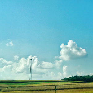 Windmill on field against sky