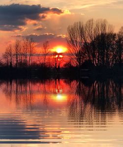 Scenic view of lake against orange sky