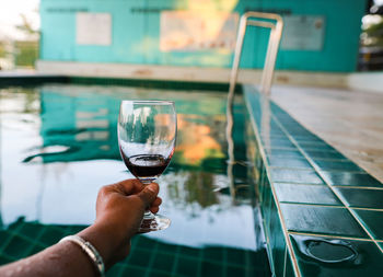 Cropped image of person holding glass of wine