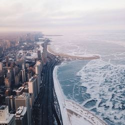 View of cityscape against cloudy sky