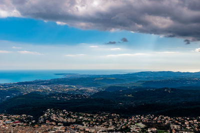 Aerial view of city by sea against sky