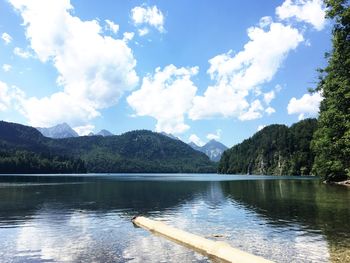 Scenic view of lake by mountains against sky