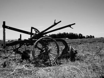 Traditional windmill on field against clear sky