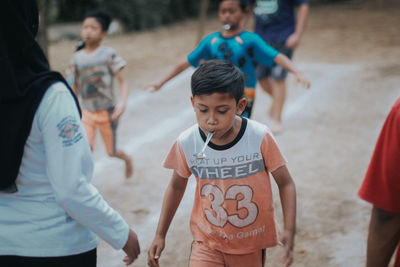 High angle view of two girls standing in front of people