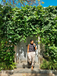 Full length of man standing by tree