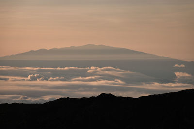 Scenic view of mauna kea, big island seen from haleakala, maui, hawaii, usa at sunrise against sky