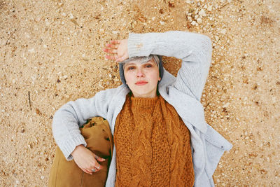 Portrait of woman lying on field