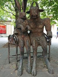 Statue on tree trunk