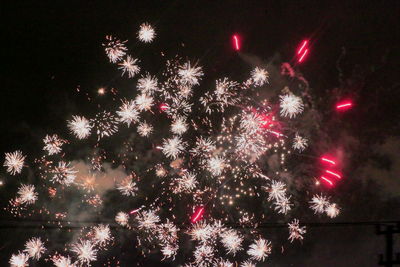 Low angle view of firework display at night