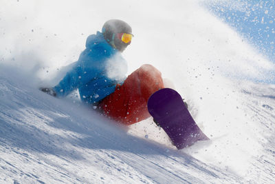 Side view of person snowboarding during winter