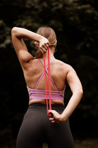 Rear view of woman standing against blurred background