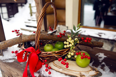 Basket of vines with green apples and berries on shrovetide on the street