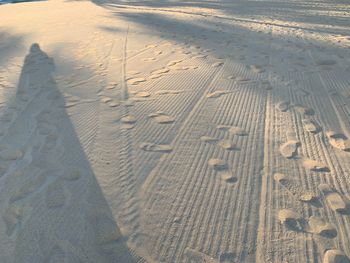 High angle view of tire tracks on beach