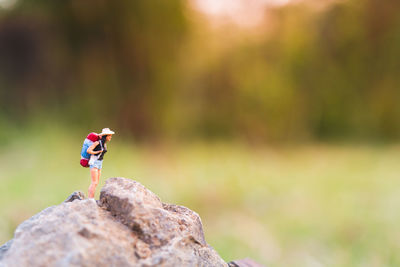 Miniature people backpackers walking with friends 