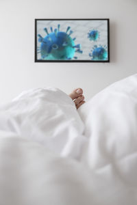 Midsection of child relaxing on bed at home