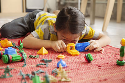 Boy playing with toy blocks on table