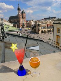 Close-up of beer on table against sky