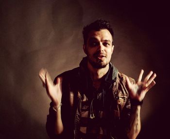 Portrait of man against black background
