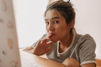 Young woman using laptop at home