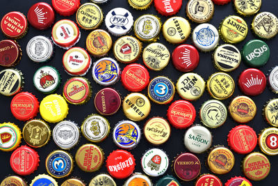 Full frame shot of multi colored bottle caps on table