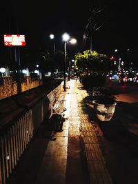 Illuminated street in city at night