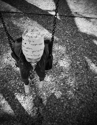 Rear view of boy walking on street