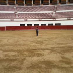 Full length of boy standing in stadium