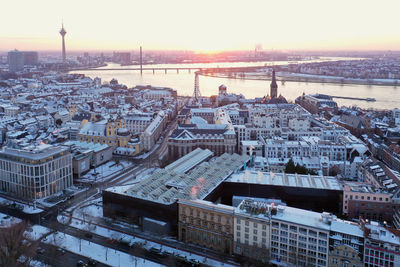 High angle view of city buildings during sunset