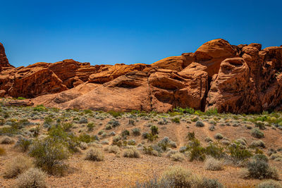 Rock formations in desert against clear blue sky