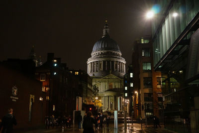 Illuminated city against sky at night