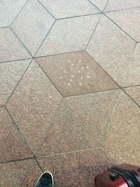 Low section of woman standing on tiled floor