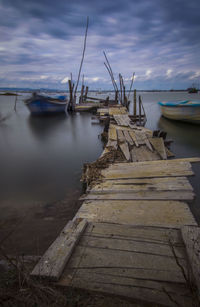 View of fishing boats moored at pier