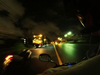 Close-up of hand car on road at night