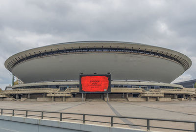 View of sign against cloudy sky