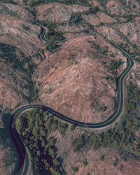 Aerial view of a serpentine road crossing some mountains in the 99 bends of queenstown. tasmania