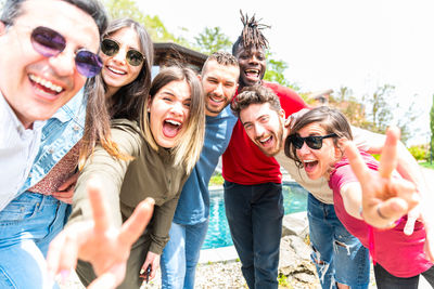Group of multiracial friends taking selfie with smartphone happy multicultural young people 