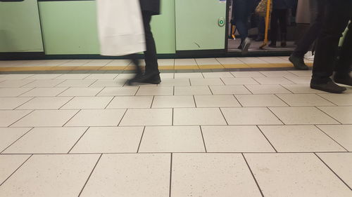 Low section of people on tiled floor