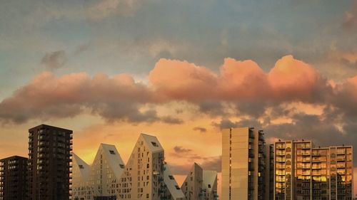 View of skyscrapers against cloudy sky