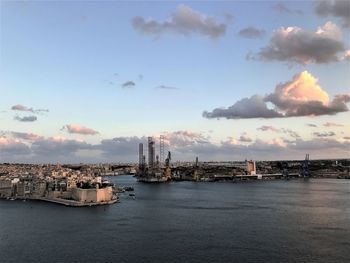 Scenic view of sea against buildings in city