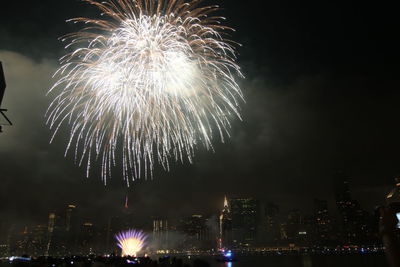 Low angle view of firework display at night